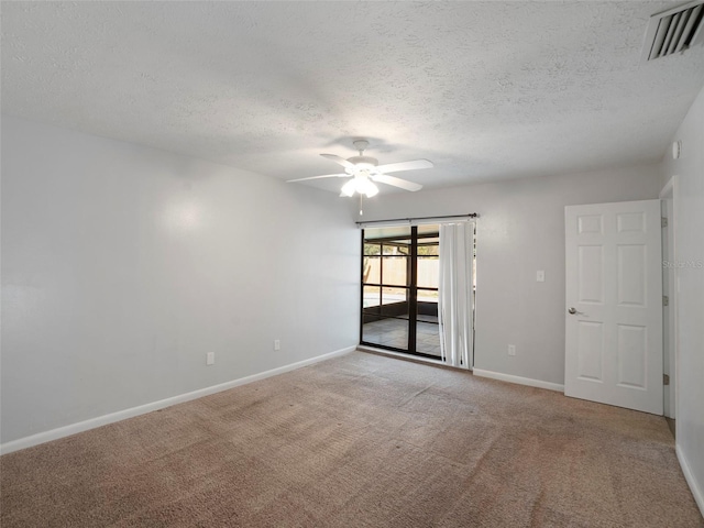 spare room featuring light carpet, a textured ceiling, and ceiling fan