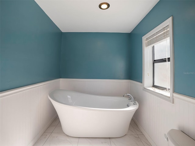 bathroom featuring toilet and a bathing tub