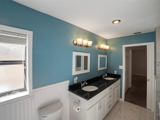 bathroom featuring vanity and toilet