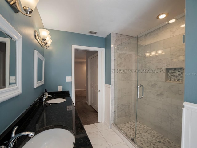 bathroom with vanity and a shower with door