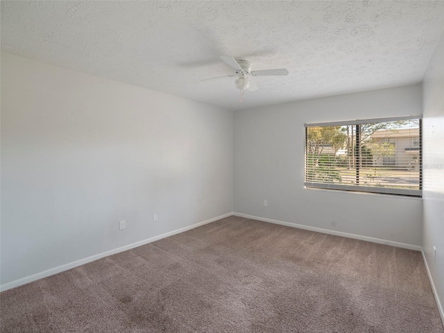 carpeted spare room with ceiling fan and a textured ceiling