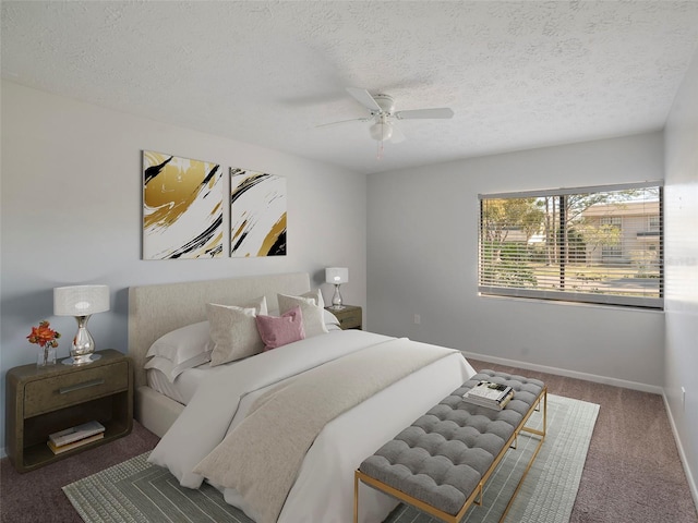 carpeted bedroom featuring ceiling fan and a textured ceiling