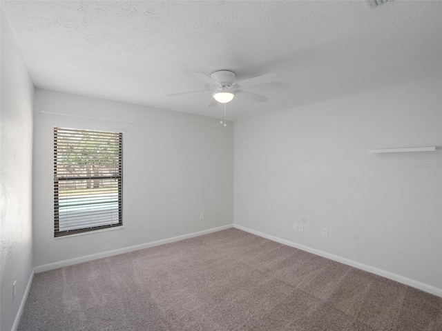 spare room with ceiling fan, carpet, and a textured ceiling