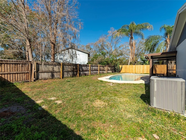 view of yard featuring cooling unit and a fenced in pool