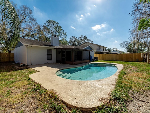 view of pool with a yard, a sunroom, and a patio