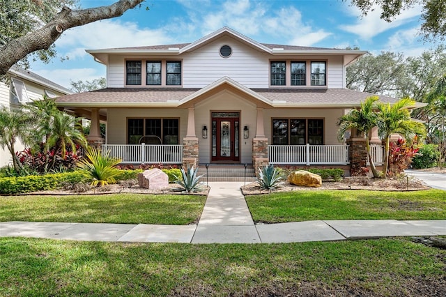 view of front facade with a front lawn and a porch