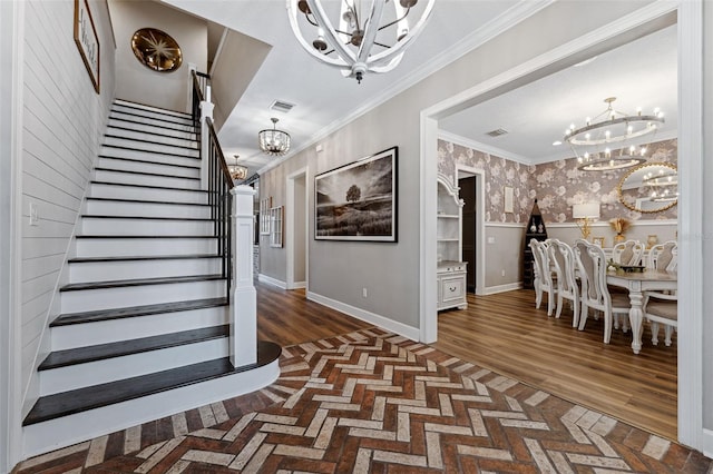 staircase with crown molding and a chandelier