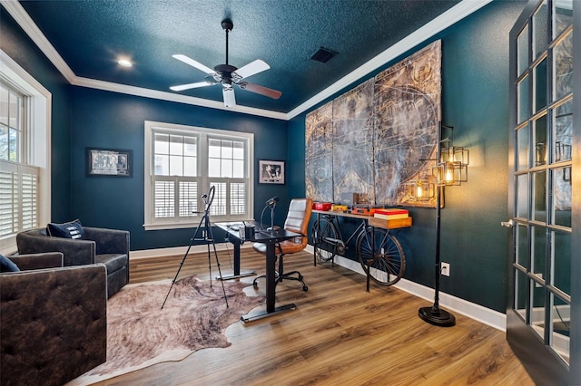 office featuring ceiling fan, ornamental molding, hardwood / wood-style floors, and a textured ceiling