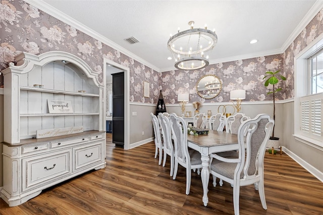 dining area featuring an inviting chandelier, dark hardwood / wood-style floors, and crown molding