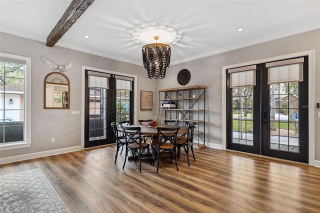 dining room featuring french doors, crown molding, a chandelier, and hardwood / wood-style floors