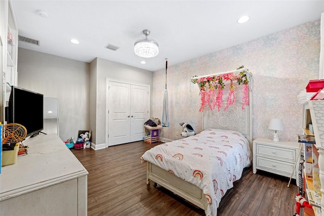 bedroom with a closet and dark hardwood / wood-style floors