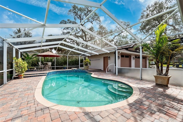 view of swimming pool featuring glass enclosure and a patio area