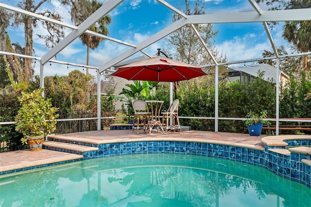 view of pool with a lanai and a patio