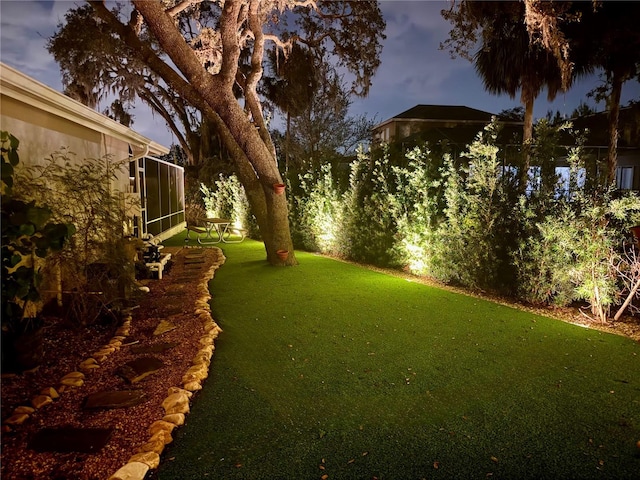 view of yard at dusk