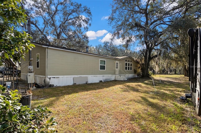 view of side of home with a lawn