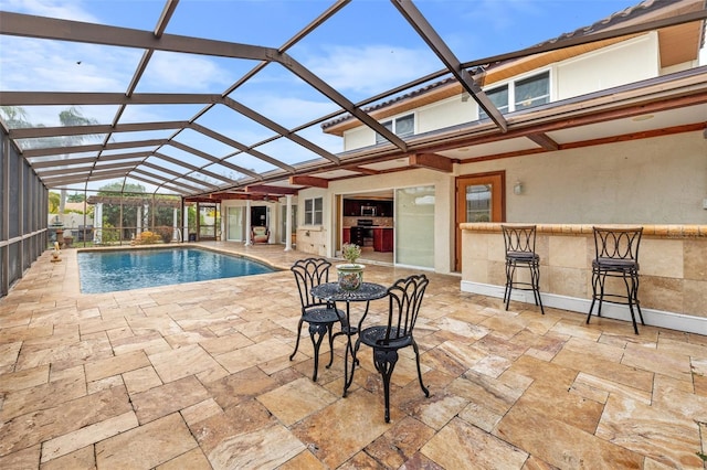 view of pool featuring a lanai, a patio area, and exterior bar