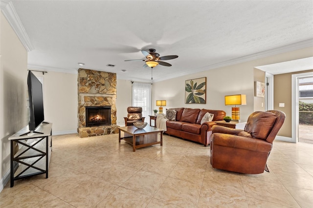 living room with crown molding, ceiling fan, a fireplace, and a textured ceiling