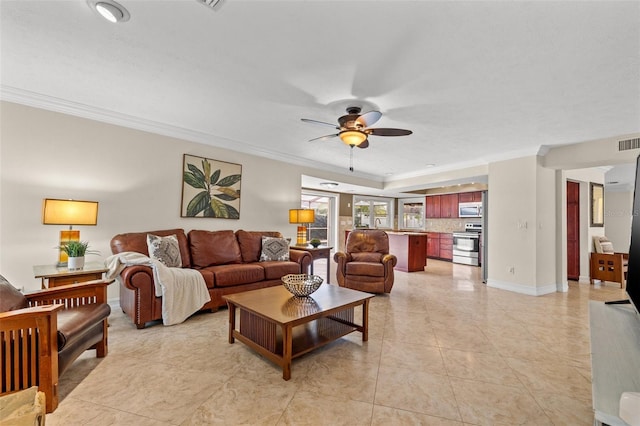 living room featuring crown molding, ceiling fan, and light tile patterned flooring