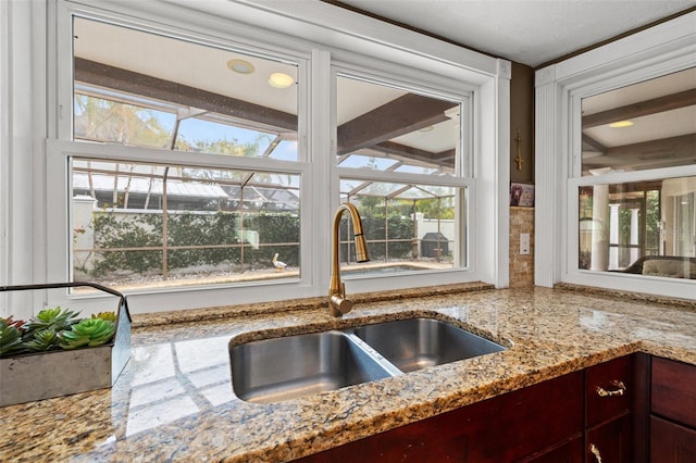 room details featuring light stone counters and sink