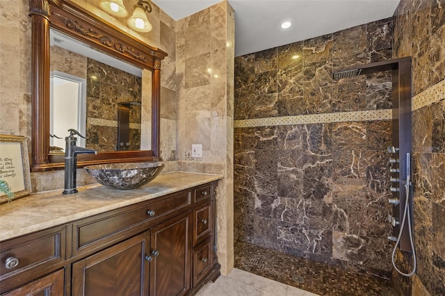 bathroom featuring vanity, tile walls, and walk in shower