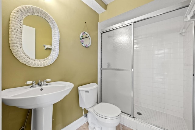 bathroom with an enclosed shower and toilet