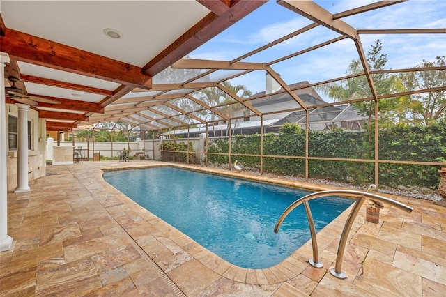 view of swimming pool with a patio and glass enclosure