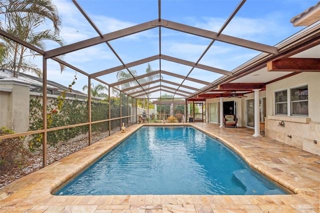 view of swimming pool with a lanai and a patio