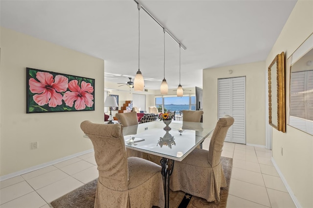 tiled dining space featuring rail lighting