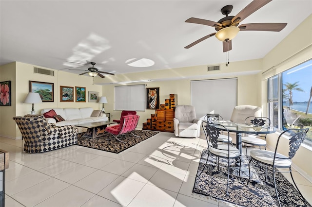 tiled living room featuring ceiling fan