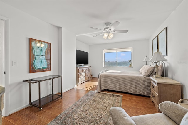 bedroom with ceiling fan and light hardwood / wood-style floors