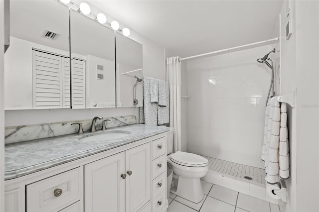 bathroom with walk in shower, vanity, toilet, and tile patterned flooring