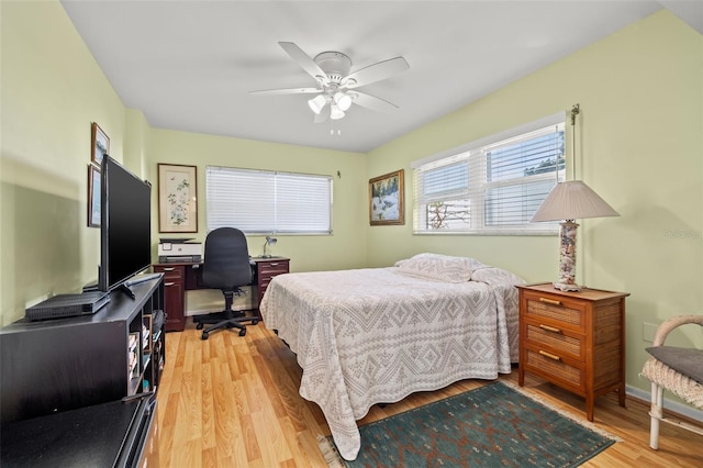 bedroom with ceiling fan and light hardwood / wood-style flooring