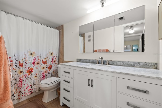 bathroom with walk in shower, tile patterned floors, toilet, and vanity