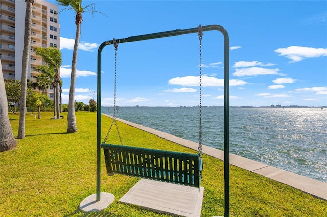 view of home's community featuring a water view and a lawn