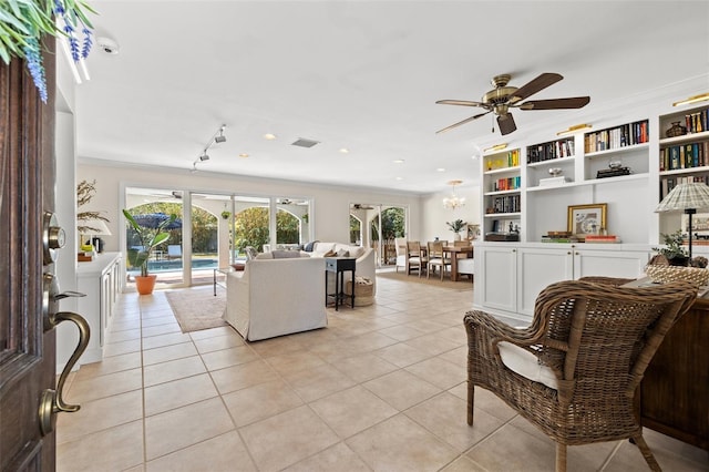 living room with ceiling fan, ornamental molding, and light tile patterned floors