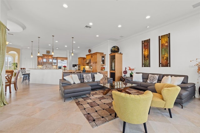 living room with crown molding and light tile patterned flooring