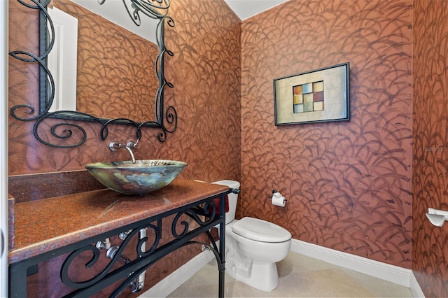 bathroom with vanity, tile patterned floors, and toilet