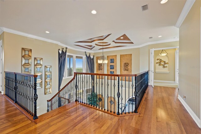 hall with crown molding and hardwood / wood-style flooring