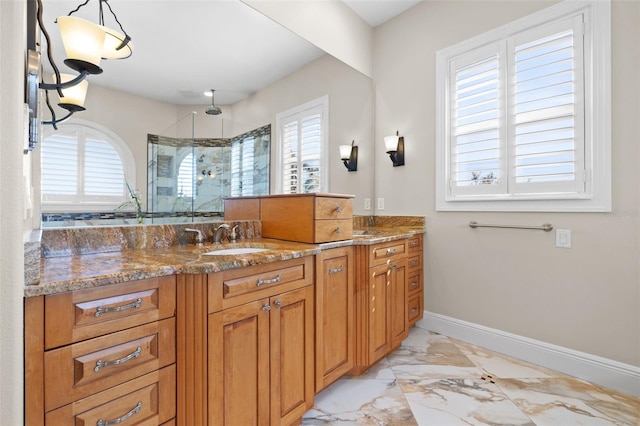 bathroom with vanity, plenty of natural light, and walk in shower