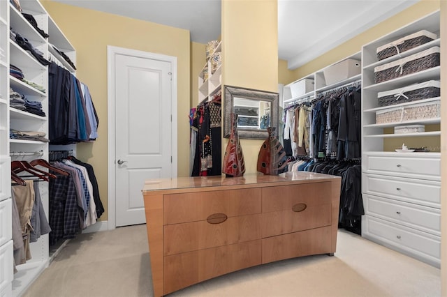 walk in closet featuring light colored carpet