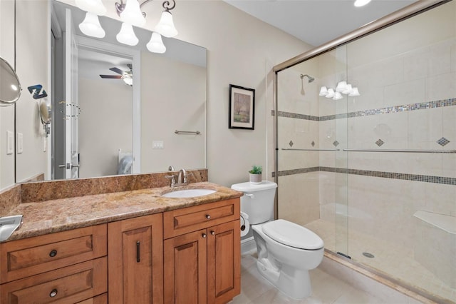 bathroom with vanity, tile patterned flooring, a shower with door, and toilet