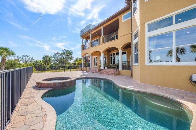 view of pool with an in ground hot tub