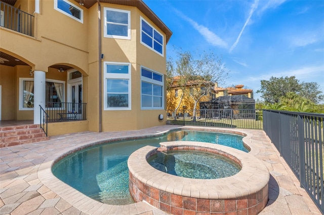 view of pool featuring an in ground hot tub