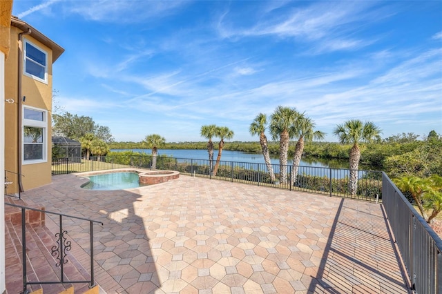 view of pool featuring an in ground hot tub, a patio, glass enclosure, and a water view