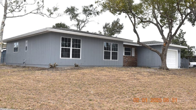 exterior space featuring a garage and a front lawn