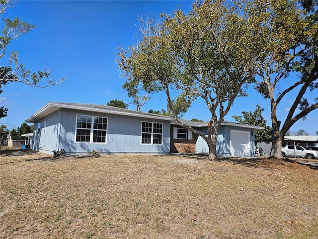 single story home featuring a garage and a front yard