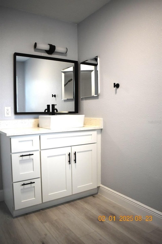 bathroom with vanity and hardwood / wood-style flooring