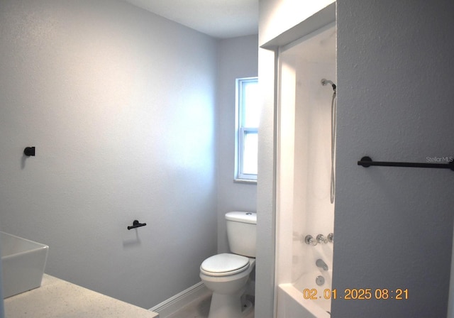 bathroom with toilet and bathtub / shower combination