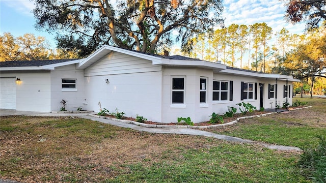 view of home's exterior featuring a yard and a garage