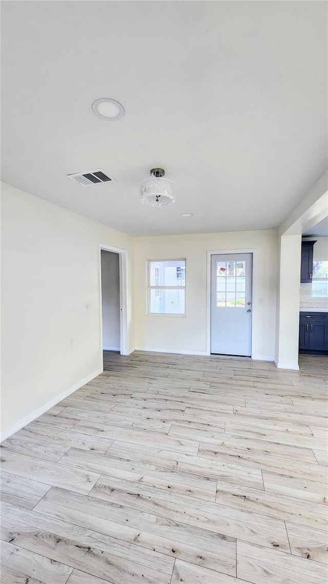 unfurnished room with light hardwood / wood-style floors